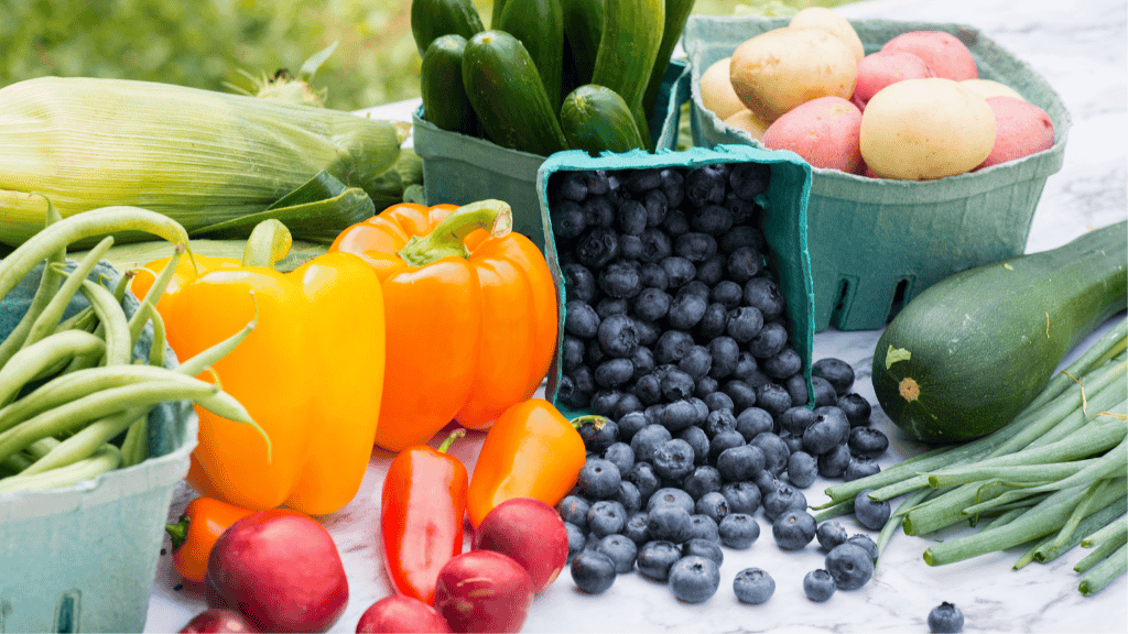 Fresh assortment of vegetables and fruits, including peppers, zucchini, and blueberries, rich in essential micronutrients.