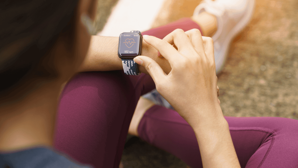 Woman monitoring heart rate on fitness tracker