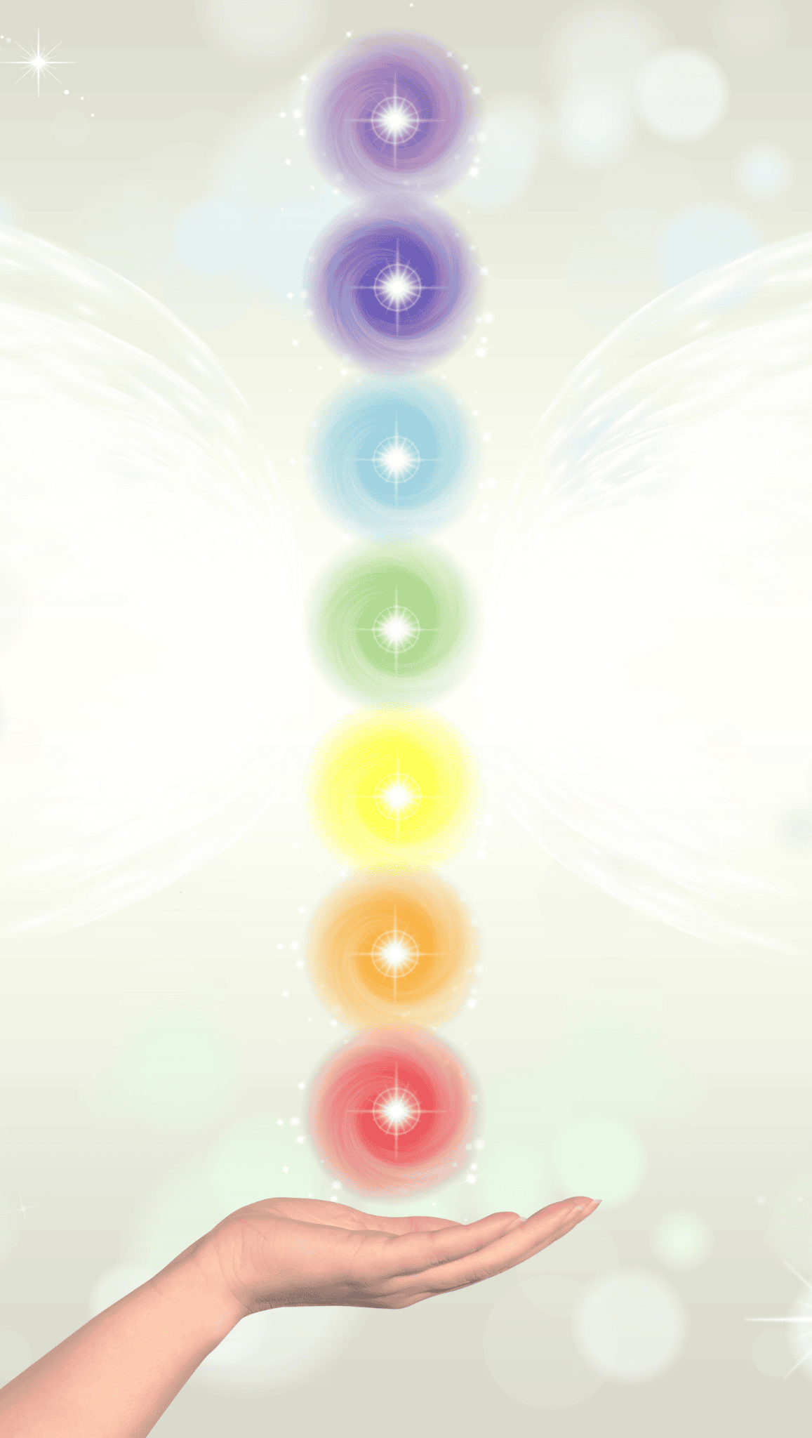 A hand is held open beneath a vertical row of seven glowing chakras, each radiating a different color of the rainbow, with a soft, ethereal background featuring light, sparkles, and faint wing-like shapes.