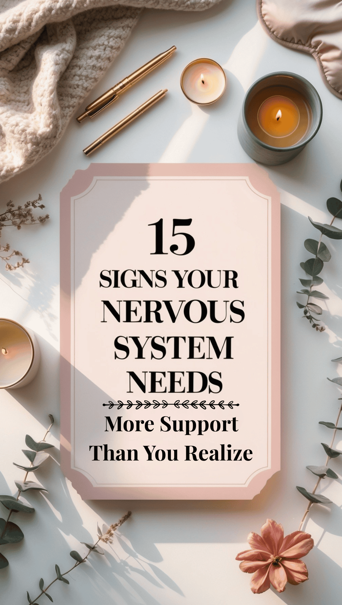 A flatlay image with candles, a knitted blanket, pens, leaves, and a pink-bordered sign that reads: “15 Signs Your Nervous System Needs More Support Than You Realize.” A cozy scene highlighting the importance of nervous system care.