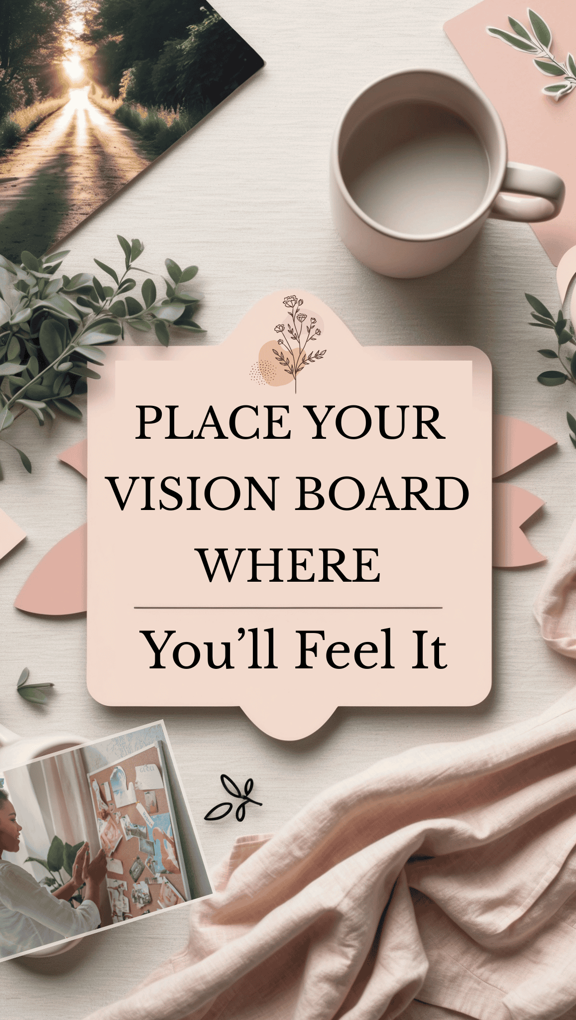 A flat lay of a desk with a coffee mug, photo, leaves, pink notebook, and fabric scarf. A sign in the center reads, “Place your vision board where you’ll feel it.” Find inspiration for your own Vision Board Ideas in the cozy setup.