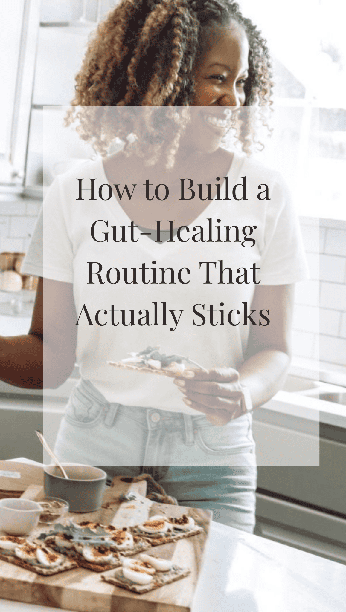 A smiling woman stands in a bright kitchen holding food, with a counter in front of her displaying crackers and spreads. Overlaid text reads, How to Build Healthy Gut Habits That Actually Stick.